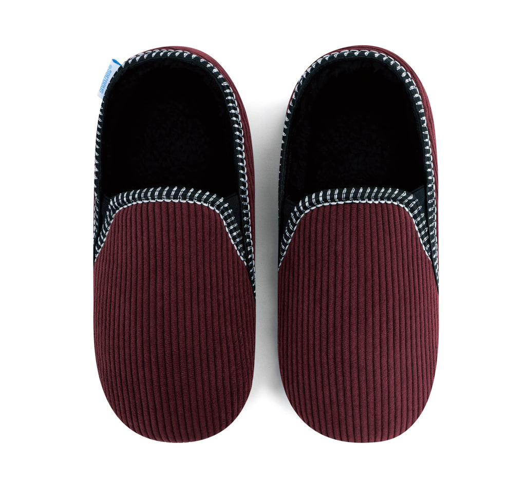 Pair of maroon slippers with textured sole and black interior on a white background