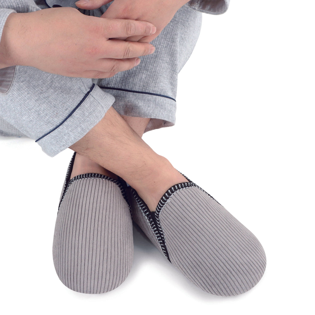 Person wearing gray ribbed socks with black trim on a white background