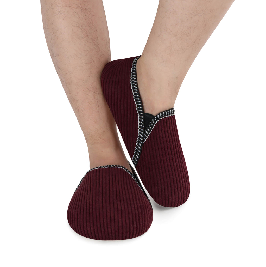 Maroon socks with textured sole worn by a person on a white background