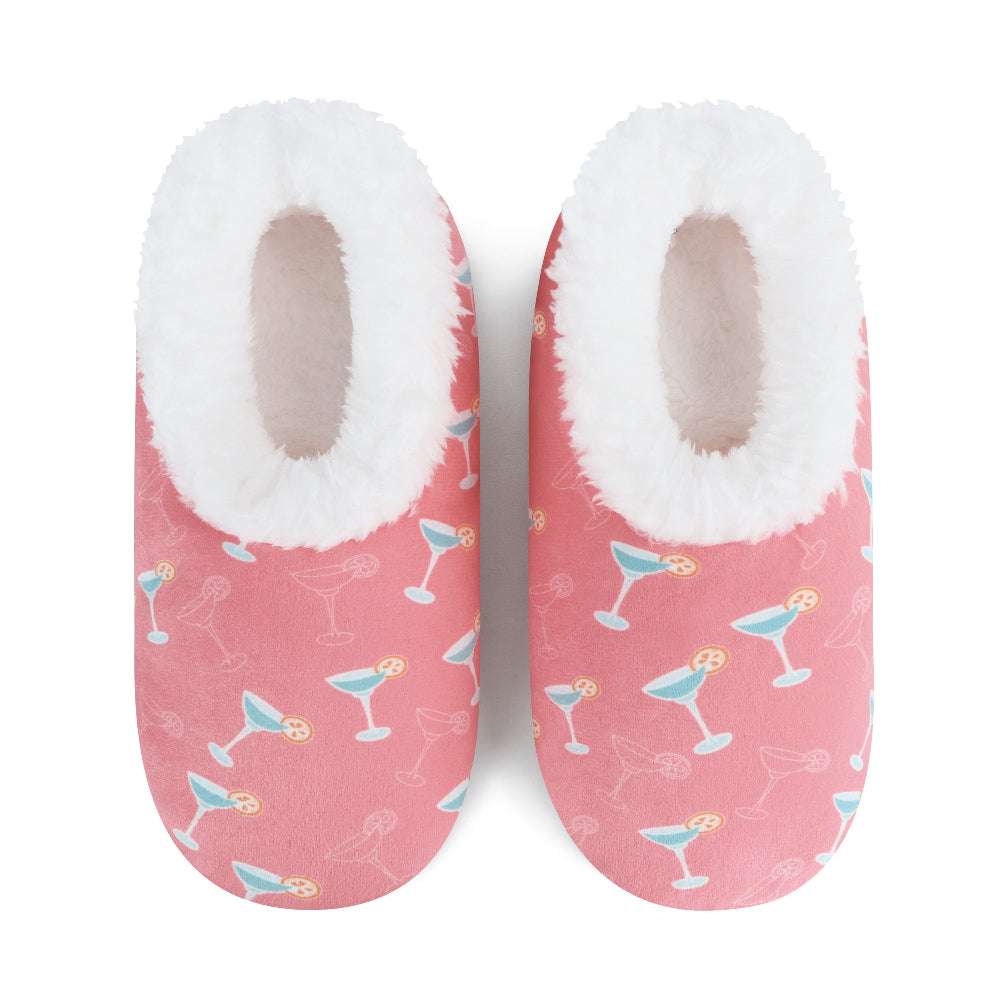 Pair of pink slippers with cocktail pattern and white fuzzy interior on a white background