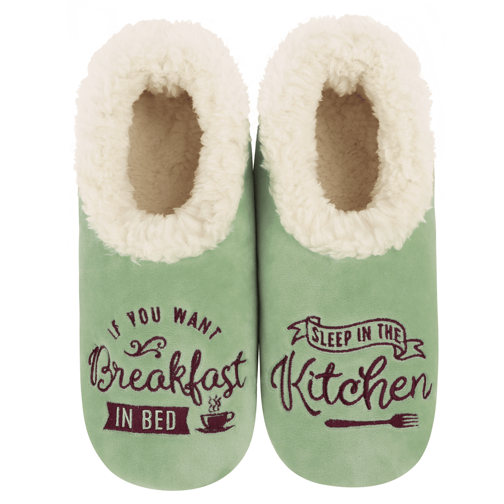 Green slippers with white fur lining and humorous text design on a white background