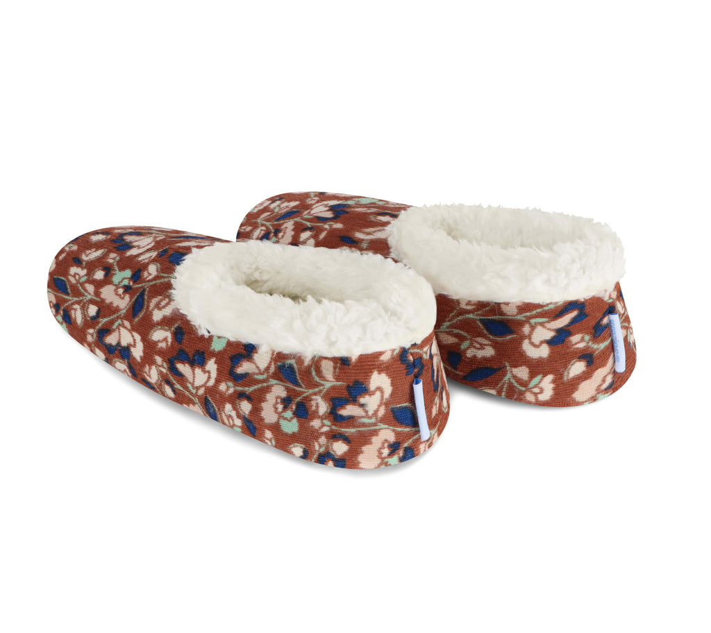 Pair of floral-patterned slippers with white lining on a white background