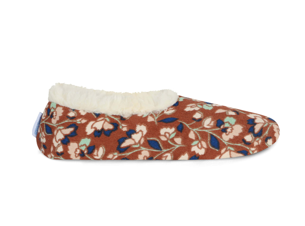 Floral patterned slipper with white lining on a white background